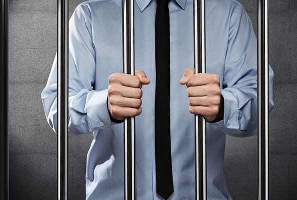 Man Wearing Tie Inside Cell Bar — St. Minneapolis, MN — Absolute Bail Bonds Man Wearing Tie Inside Cell Bar — St. Minneapolis, MN — Absolute Bail Bonds