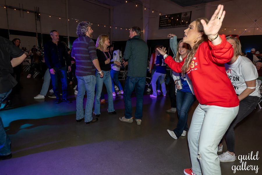 A group of people are dancing on a dance floor.