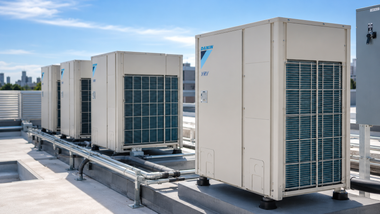 Rows of rooftop HVAC units on a sunlit commercial building