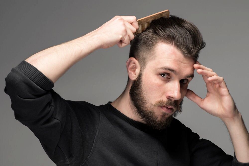 Man With Dark Hair and Beard Combing His Hair — Bermann Barbershop in Casey, ACT