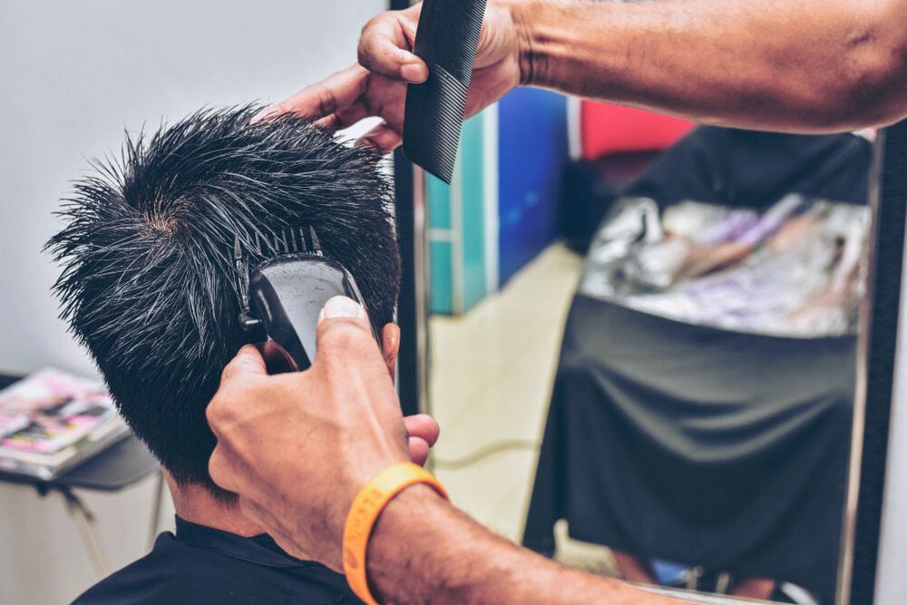 A Person Getting a Haircut With Clippers — Bermann Barbershop in Casey, ACT