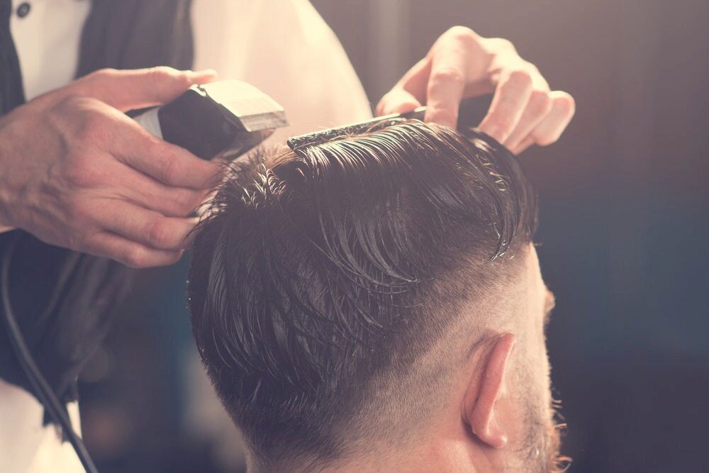 Barber Cutting a Man's Hair With Clippers; a Fade Haircut in Progress — Bermann Barbershop in Ngunnawal, ACT