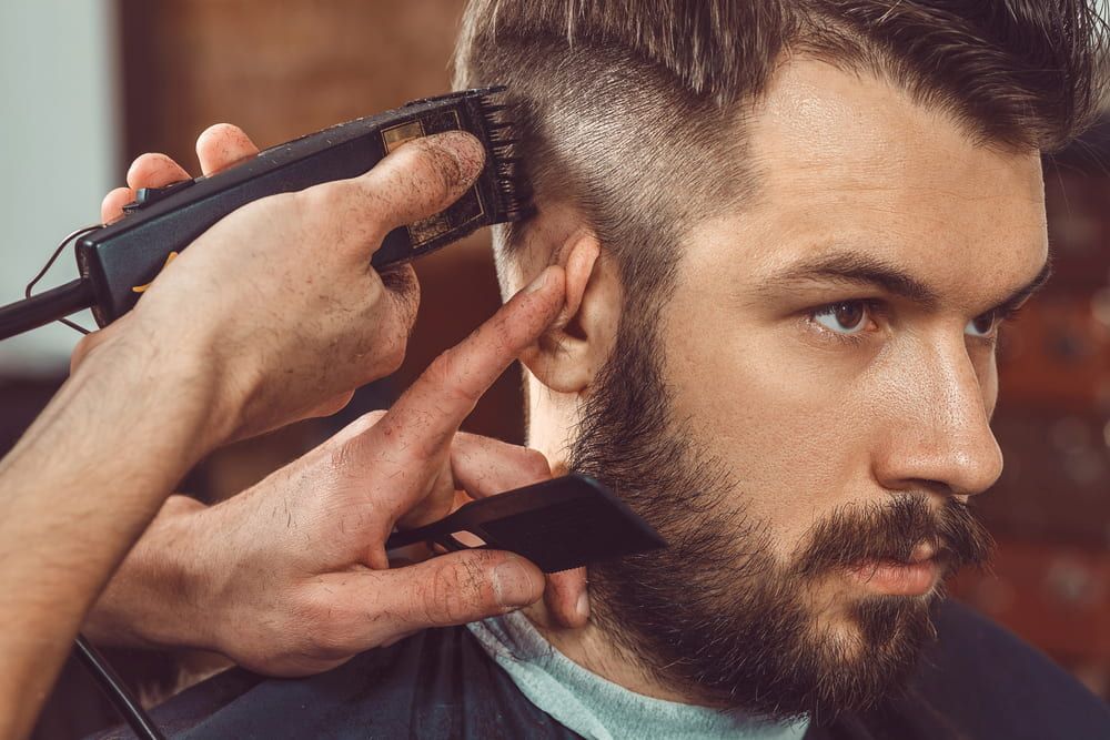 Barber Using Clippers to Cut a Man's Hair, Creating a Fade — Bermann Barbershop in Casey, ACT