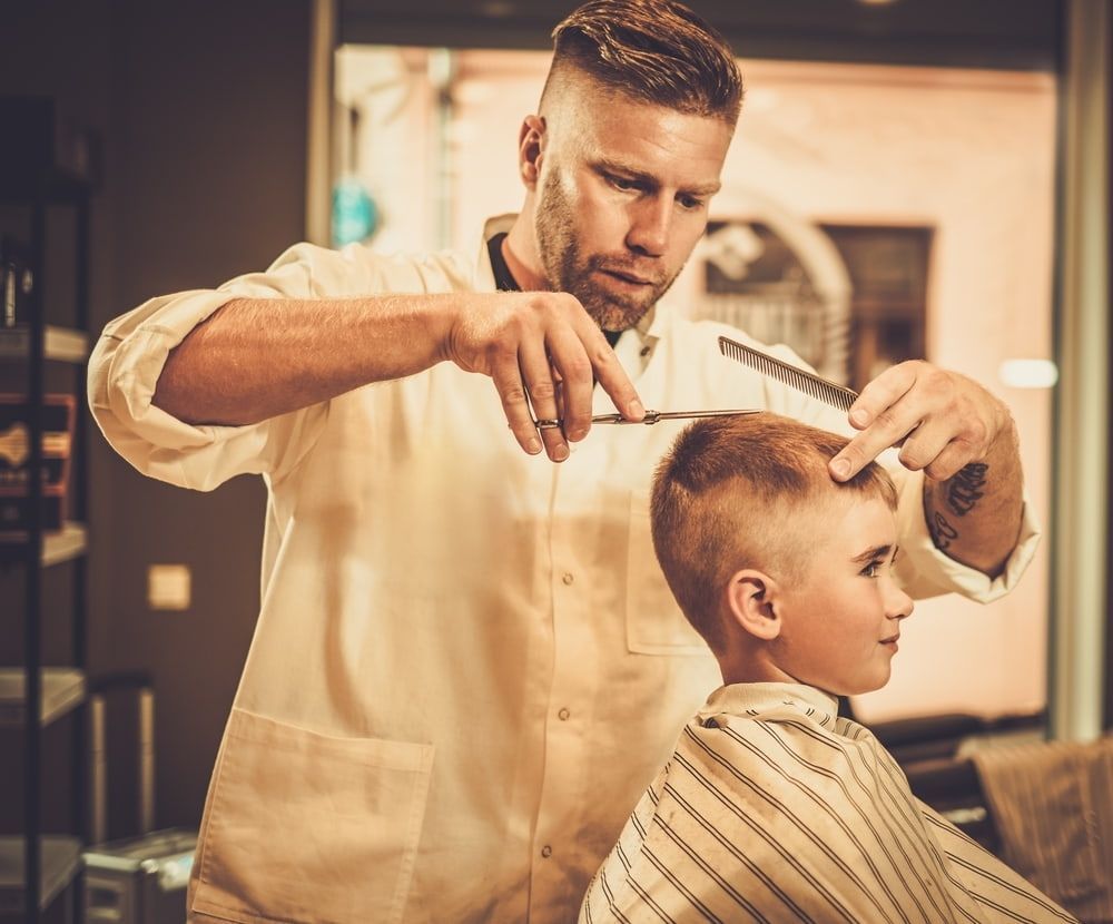 Barber Giving a Young Boy a Haircut in a Barber Shop — Bermann Barbershop in Casey, ACT