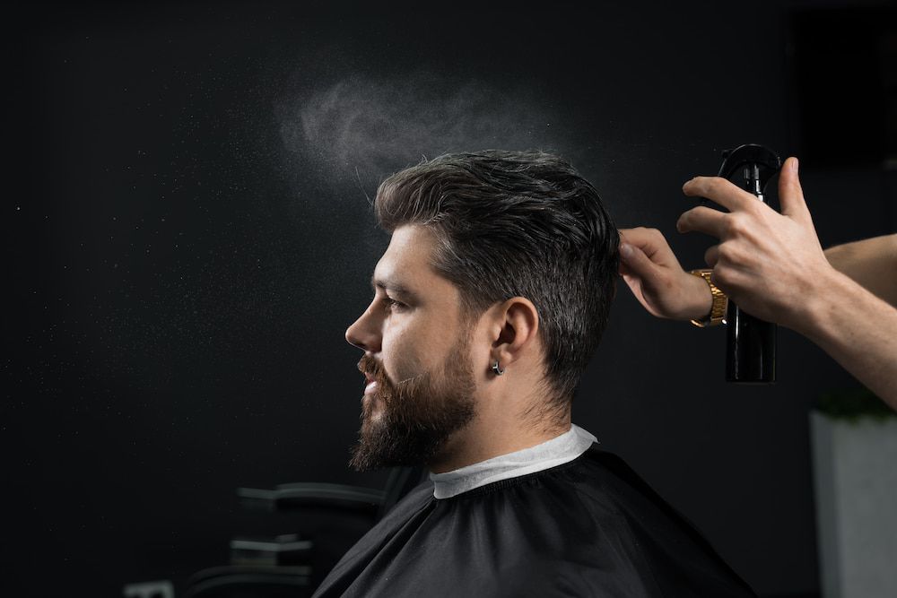 Man at Barber, Receiving Hairspray — Bermann Barbershop in Nicholls, ACT