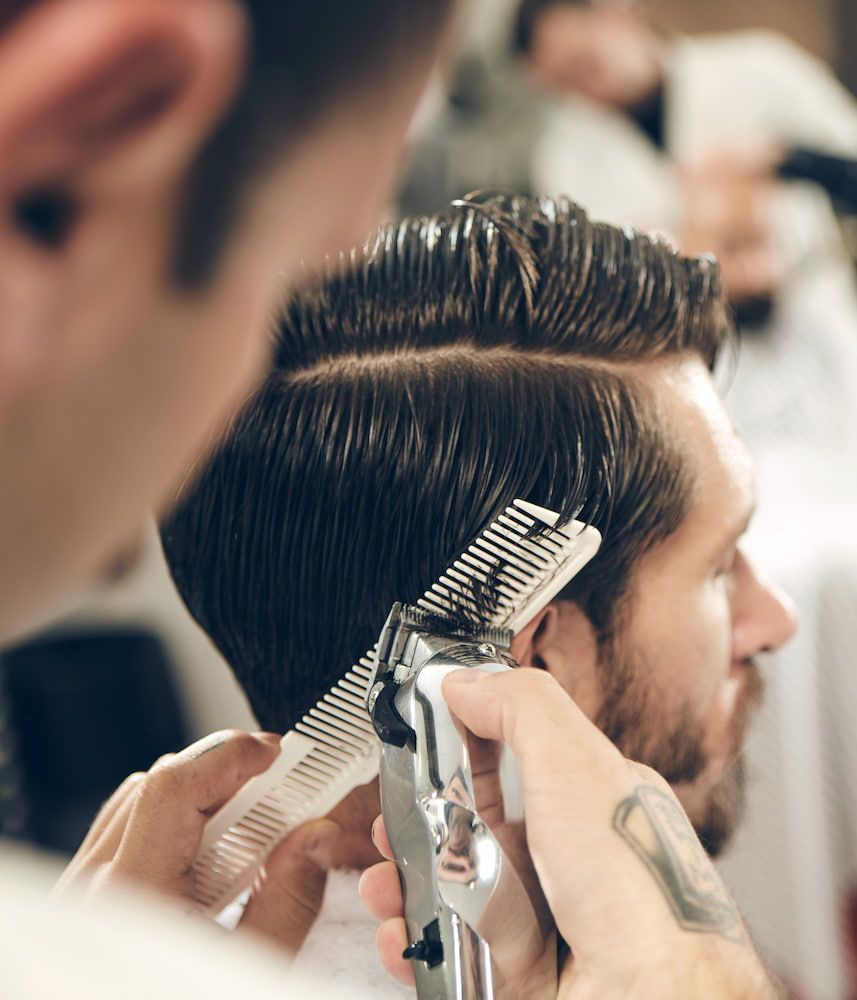 Barber Giving a Man a Haircut With Clippers and a Comb; Indoor Setting — Bermann Barbershop in Nicholls, ACT