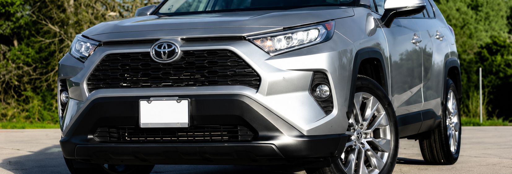 Front view of a silver Toyota SUV parked on a road in daylight