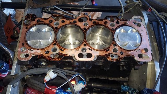 A close up of a cylinder head of a car engine.