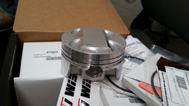A piston is sitting on top of a box that says sim on it