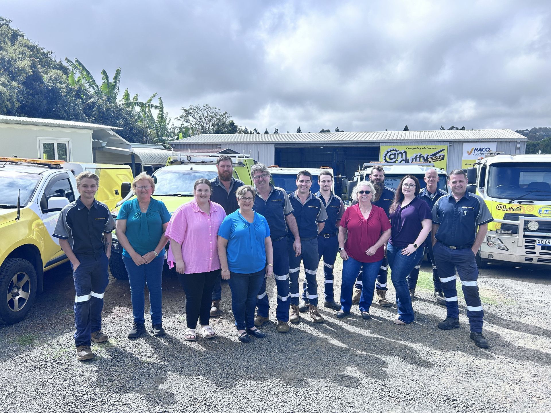 People standing in a group photo in front of cars — Cam Duffy Autos In Atherton, QLD