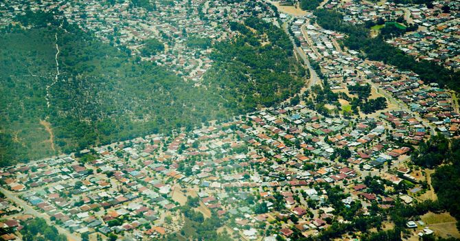 An aerial view of a residential area surrounded by trees.