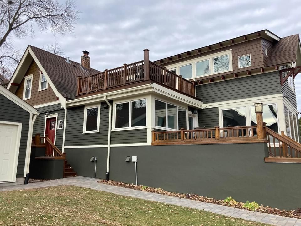 A large house with a large deck on top of it.