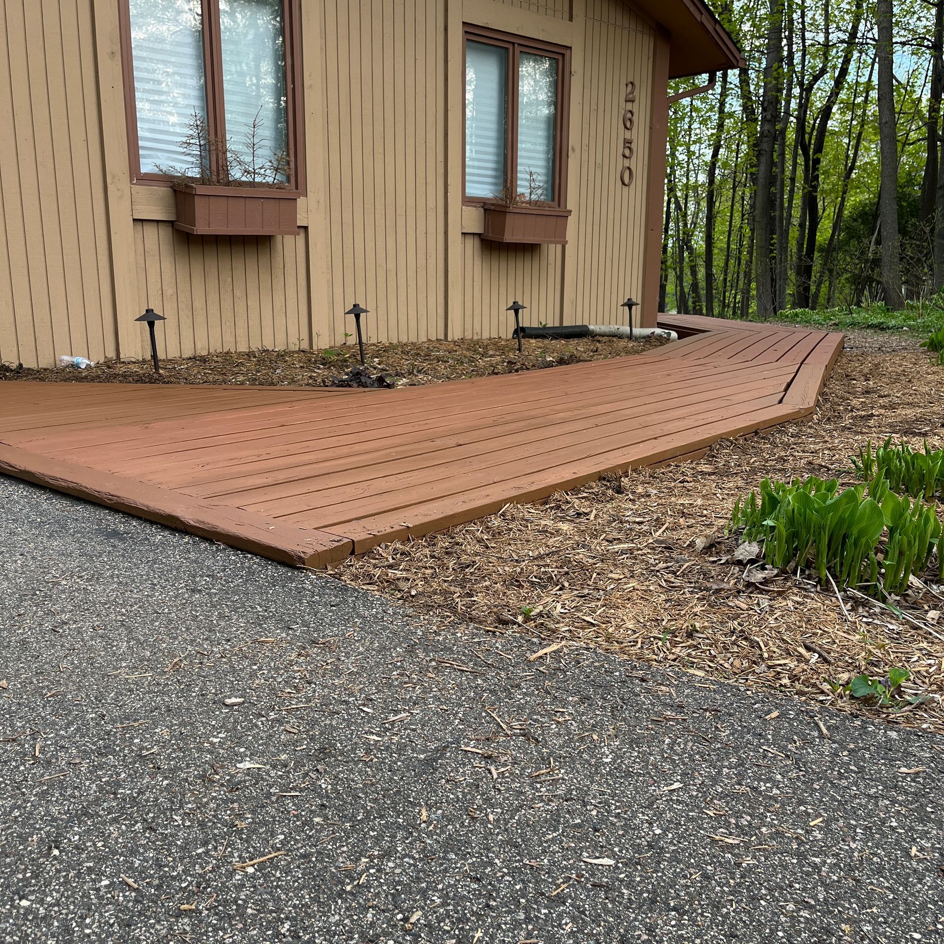 A house with a wooden walkway leading to it