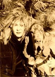 A black and white photo of a woman and a dog taken on 12/10/98