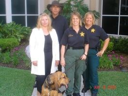 A group of people posing for a picture with a dog