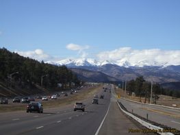 A highway with snowy mountains in the background