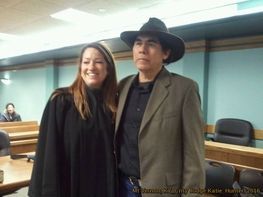 A man and a woman are posing for a picture in a courtroom