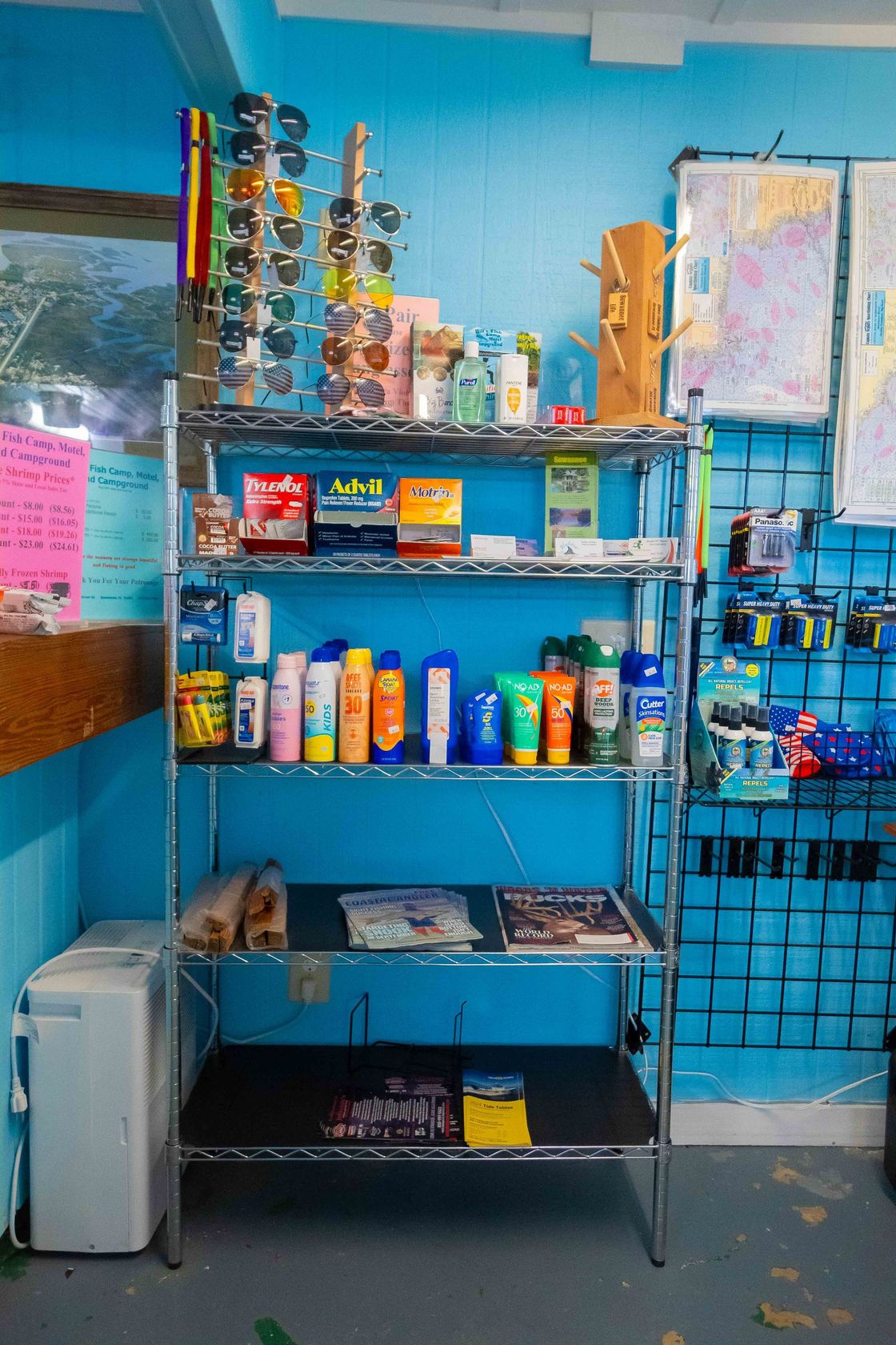 Store shelf with colorful bottles, cans, and snacks against a blue wall