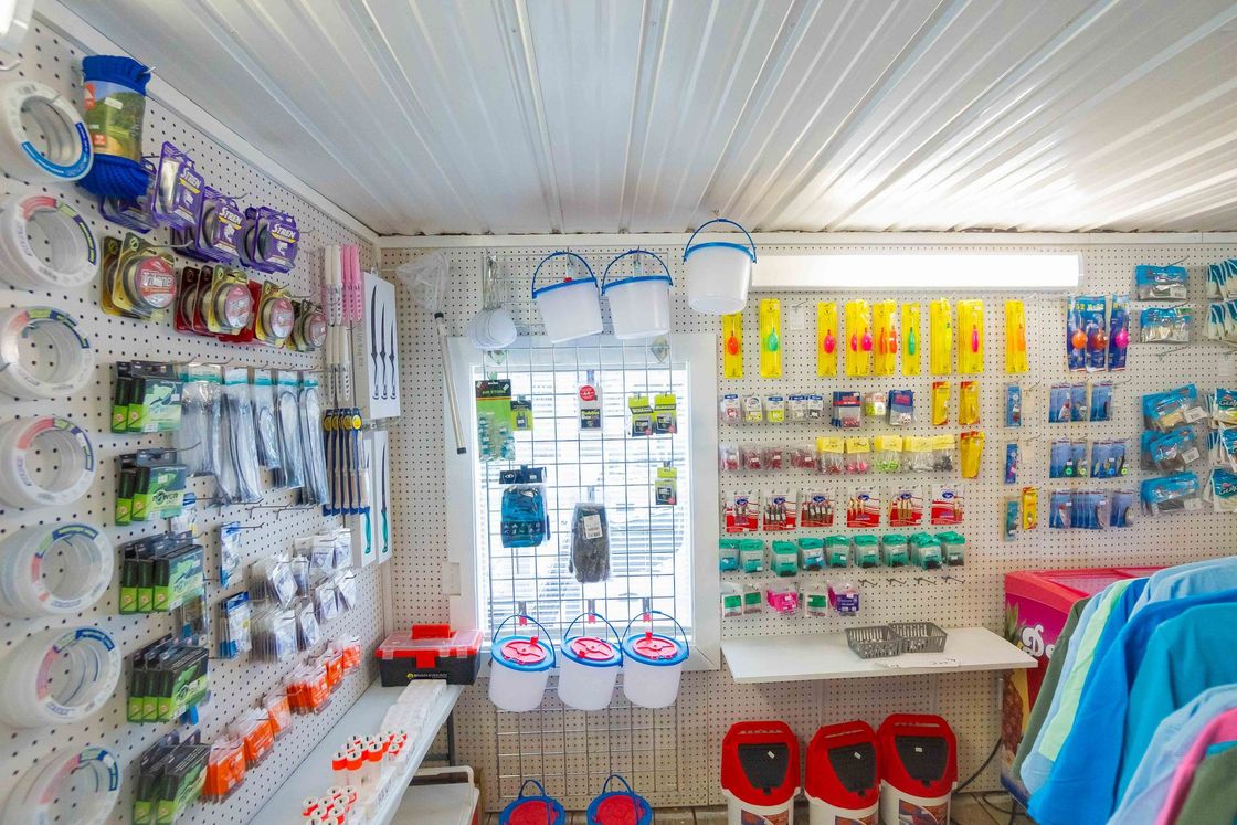 Brightly lit shop interior with pet supplies, hanging accessories, and colorful packaged products on shelves