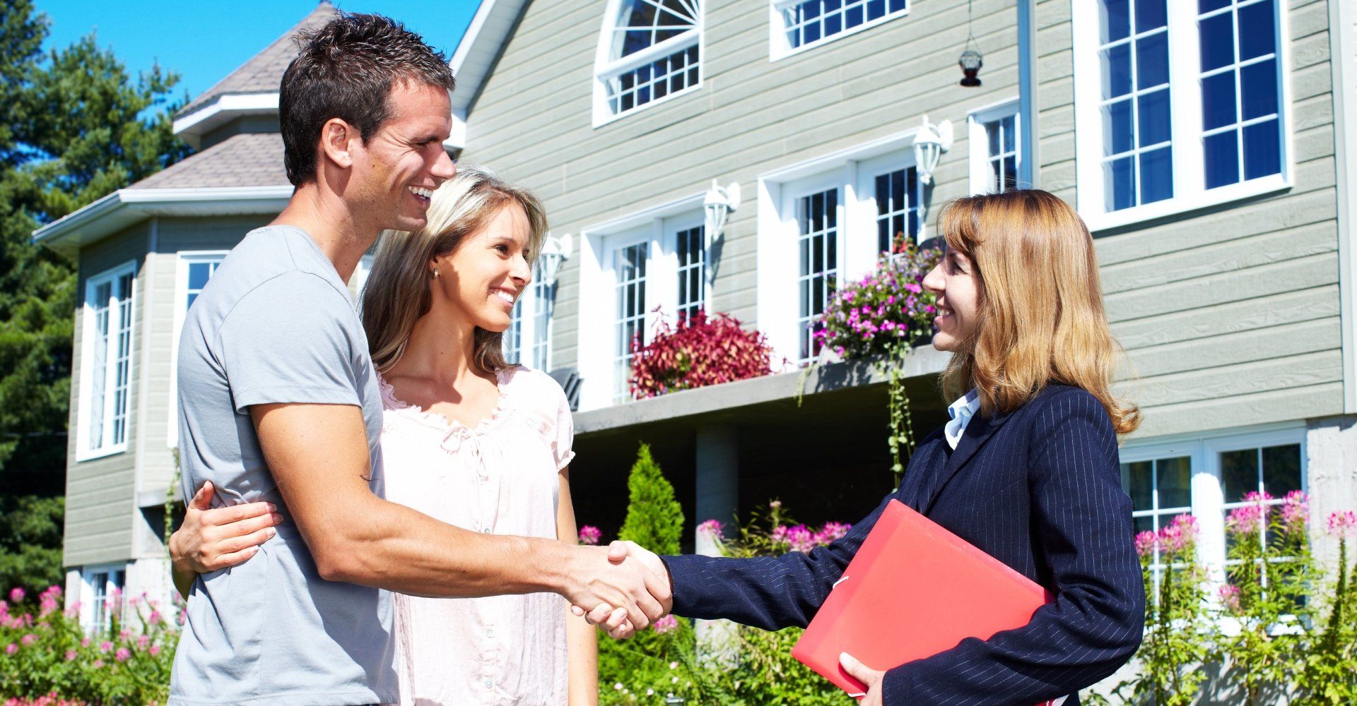 Couple shaking hands with realtor