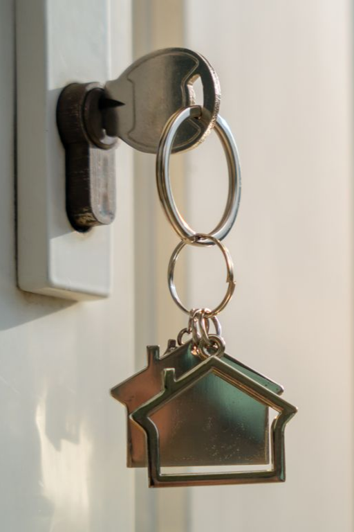 House key hanging in front door lock, symbolizing sell process and buy my house fast solution. House key hanging in front door lock, symbolizing sell process and buy my house fast solution.