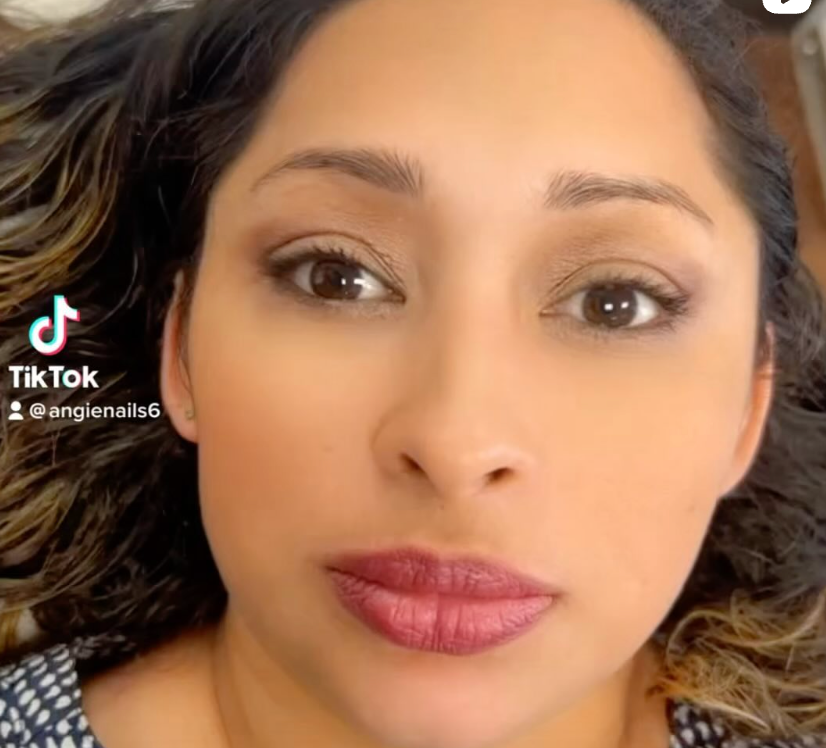 A close up of a woman 's face with a tik tok logo in the corner