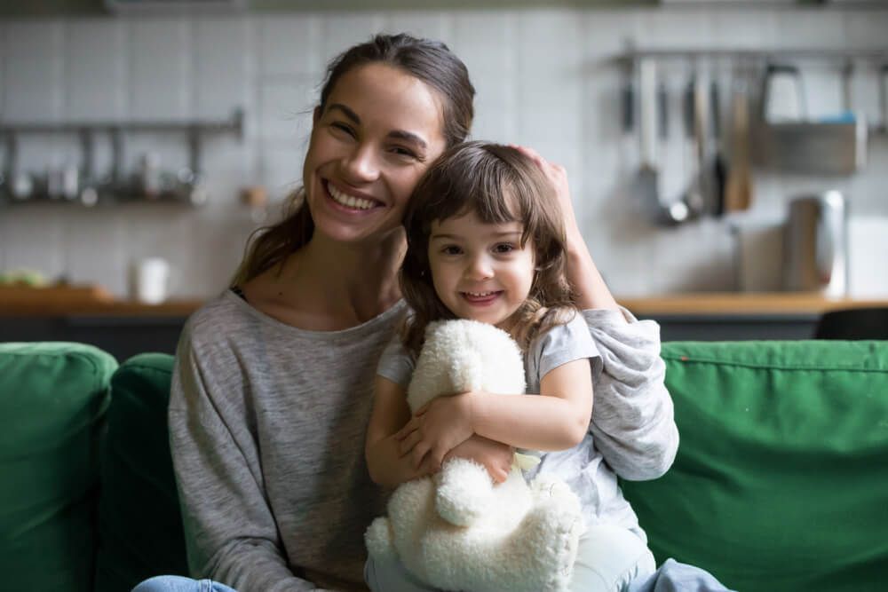 Mother Holds Child with Teddy Bear in a Legal Setting — Family Law in Wagga Wagga