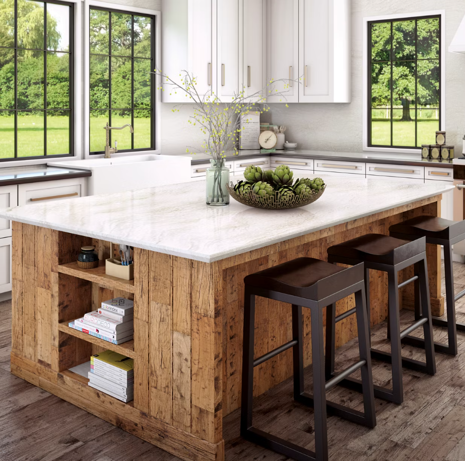 White kitchen with island and seating, white cabinets, and dining area with sunlight.