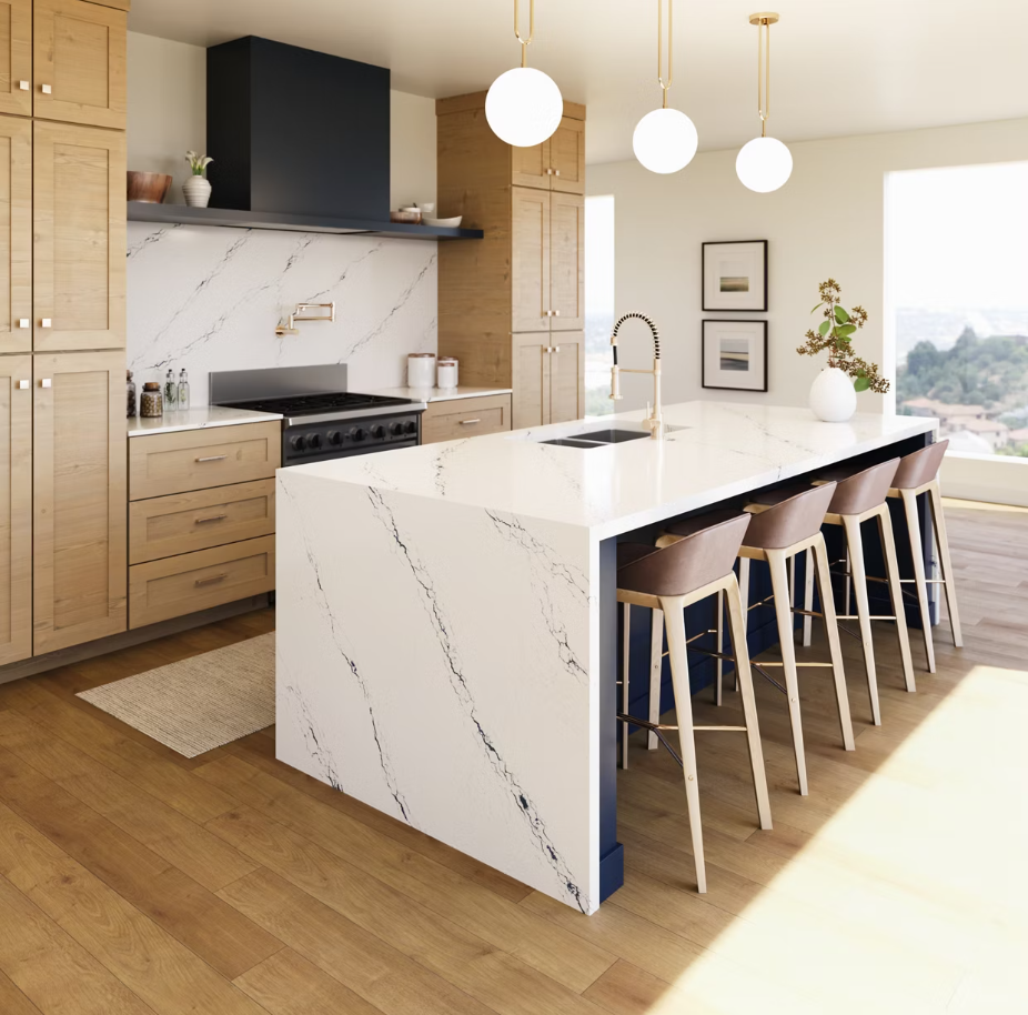 Modern kitchen with white countertops, wooden cabinets, and bar stools.