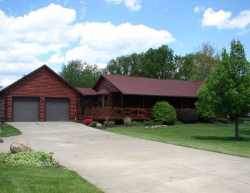 A house with a red roof and a driveway