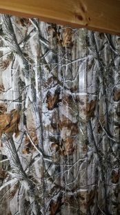 A close up of a camouflage wallpaper on a wall.