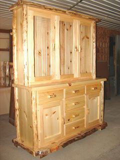 A wooden cabinet with drawers and doors is sitting in a room.