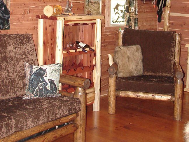 A living room with wooden furniture and a wine rack