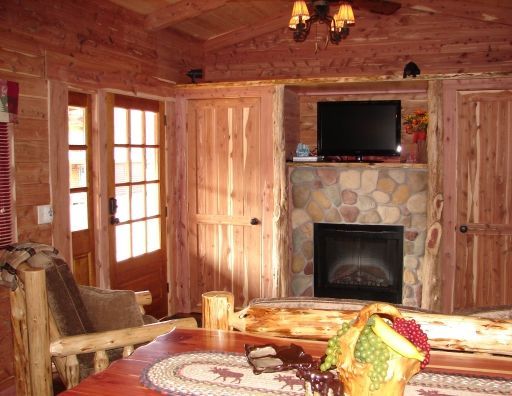 A living room with a fireplace and a flat screen tv