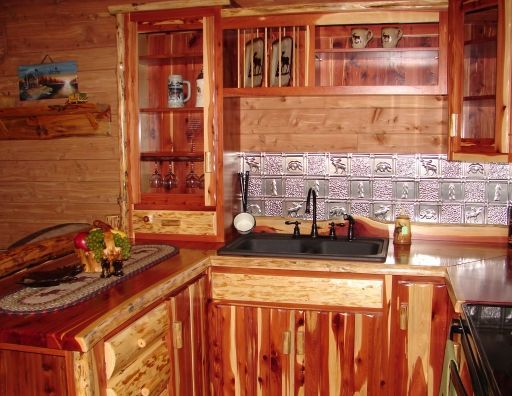 A kitchen with wooden cabinets and a sink