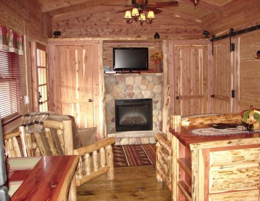 A living room with a fireplace and a flat screen tv