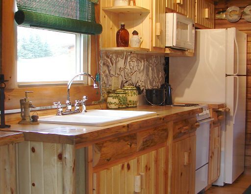 A kitchen with wooden cabinets and a white refrigerator