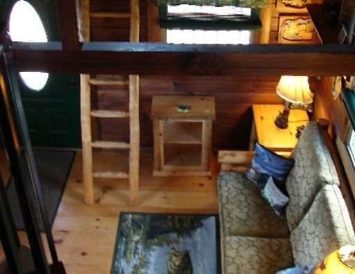 An aerial view of a living room with a couch and a ladder
