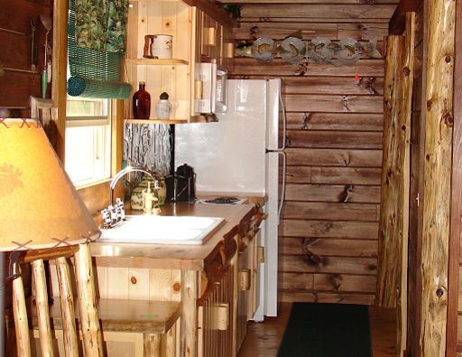 A kitchen with a white refrigerator and a sink