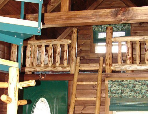 A wooden house with a staircase and a ladder