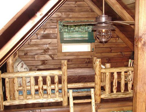 A wooden cabin with a ceiling fan and a window