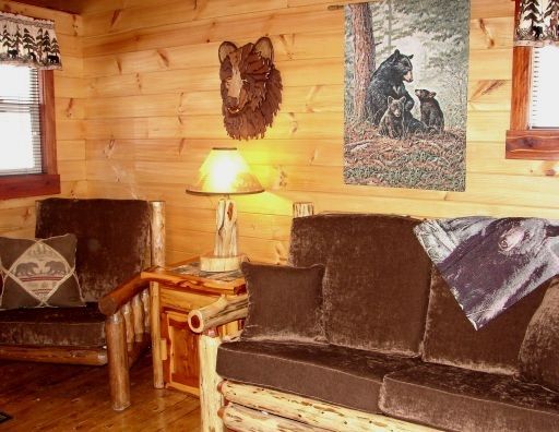 A living room with a couch a chair and a lamp
