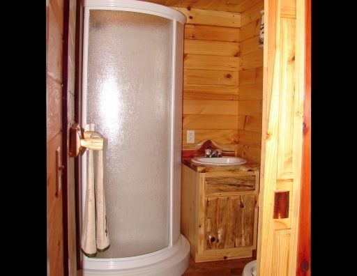 A bathroom with a shower and a sink in it