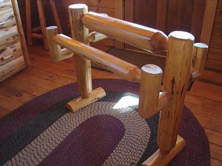 A wooden fence is sitting on a rug on a wooden floor.