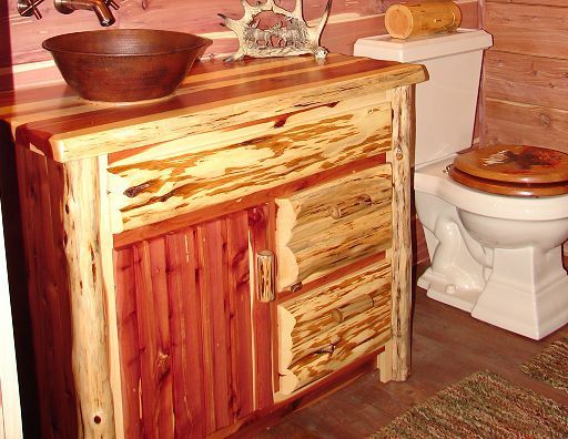 A bathroom with a wooden vanity and a toilet