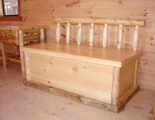 A wooden bench is sitting in front of a wooden wall