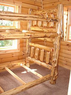 A bunk bed made of logs in a log cabin