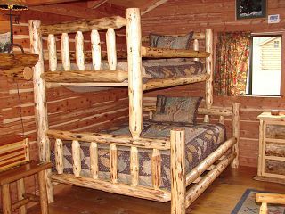A bunk bed made of logs in a log cabin.