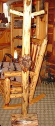 A wooden rocking chair is sitting on top of a wooden post in a room.