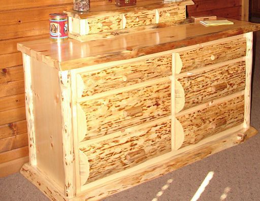 A wooden dresser with a can of soda on top of it